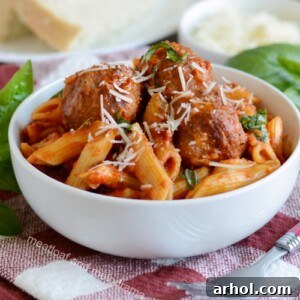 Instant Pot Pasta and Meatballs garnished with fresh basil.