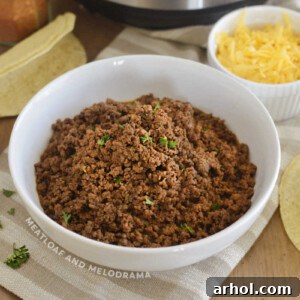 Instant Pot Ground Beef Taco Meat in a white bowl, garnished with fresh cilantro.