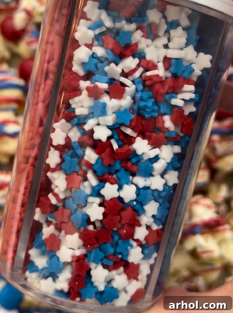 Stars and Stripes Popcorn Treat 6 Star sprinkles being shaken over patriotic popcorn mixture, adding a final decorative touch