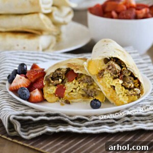 breakfast burritos made in the air fryer on a plate with strawberries and blueberries