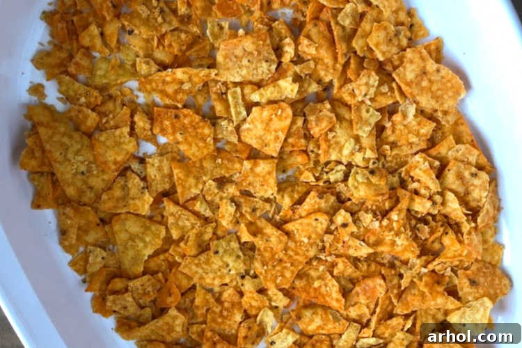A baking dish with a layer of perfectly crushed Nacho Cheese Doritos forming the base of the casserole.