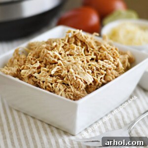 shredded instant pot salsa chicken in a white serving dish