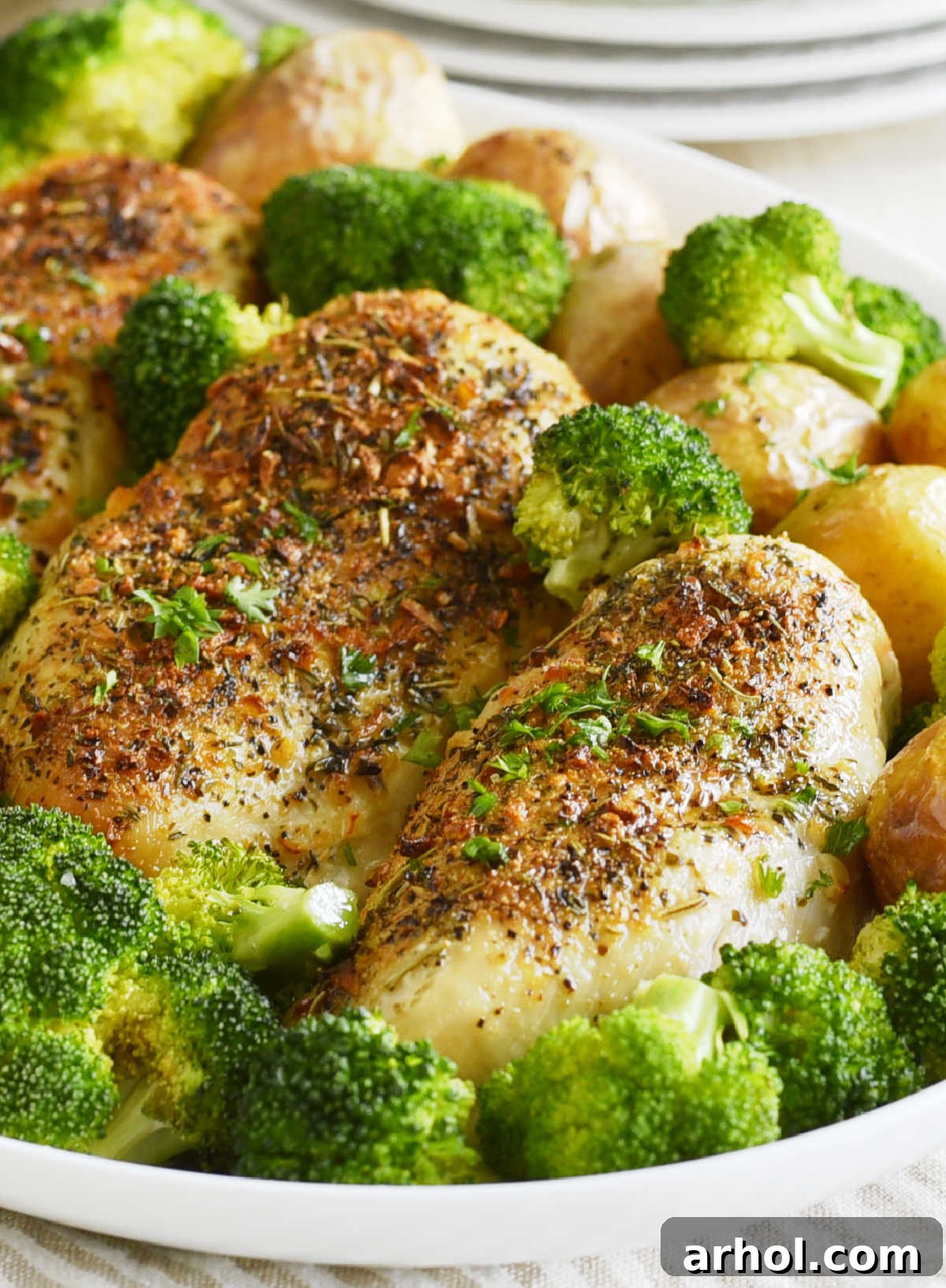 Platter with golden air-fried chicken breasts, crispy baby potatoes, and vibrant green broccoli florets