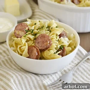 instant pot cabbage and noodles and kielbasa in white bowl