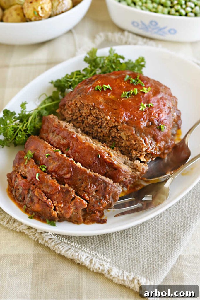 A beautifully glazed meatloaf, generously topped with vibrant fresh parsley, presented on an elegant white platter, inviting diners to a comforting and delicious meal.