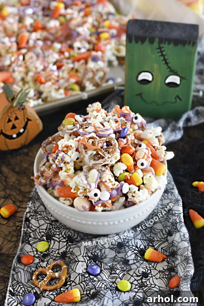 Halloween popcorn mix with pretzels and candy in a bowl, a festive and easy Halloween snack