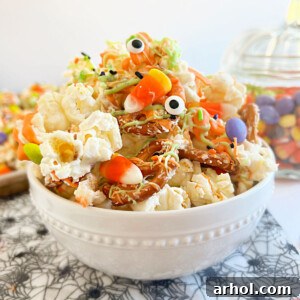 Monster Munch Halloween popcorn with pretzels, candy eyes, and candy on the table
