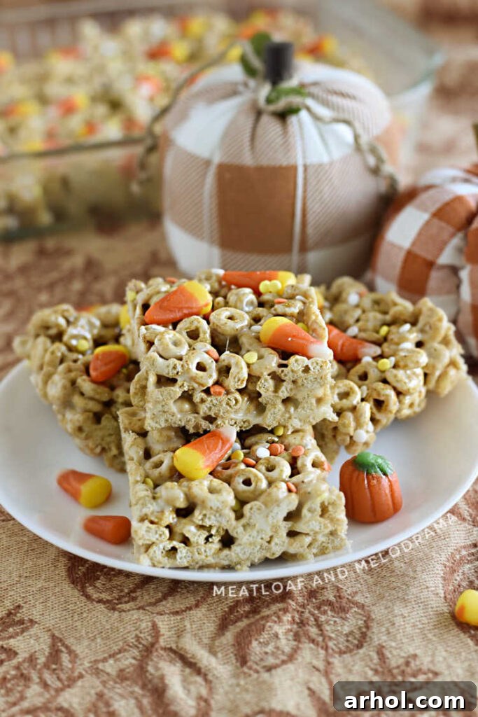 pumpkin spice cheerios marshmallow treats with candy corn and sprinkles on a plate