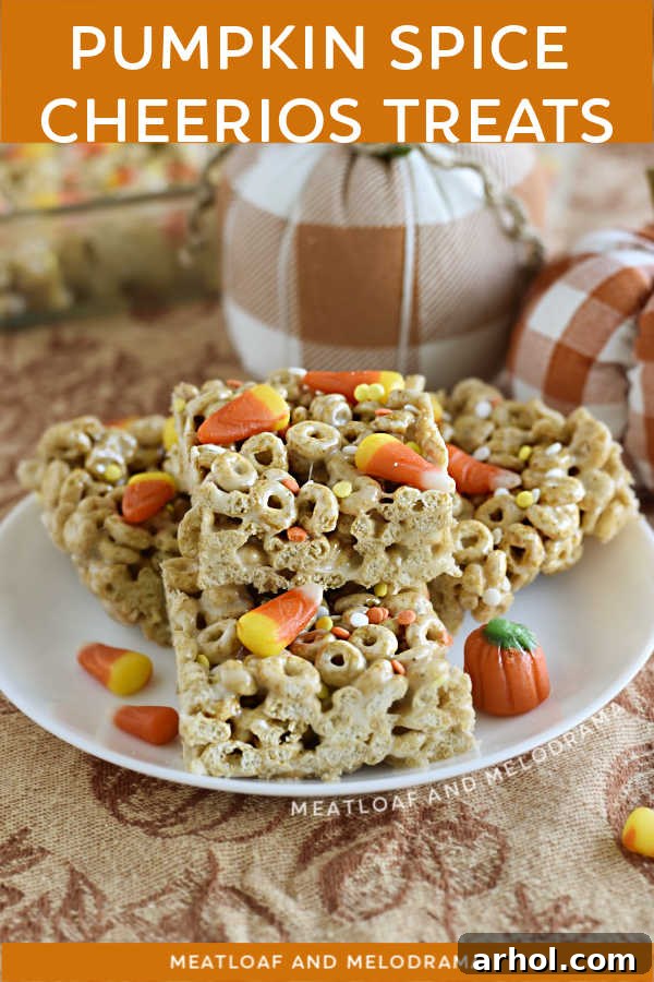 Pumpkin Spice Cheerios Treats with candy corn and fall candy on a plate with pumpkins
