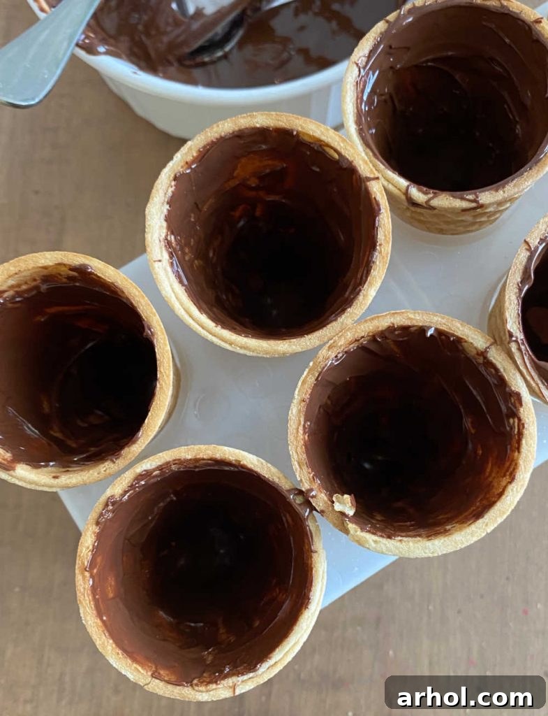 sugar cones with melted chocolate inside, showing the initial chocolate lining