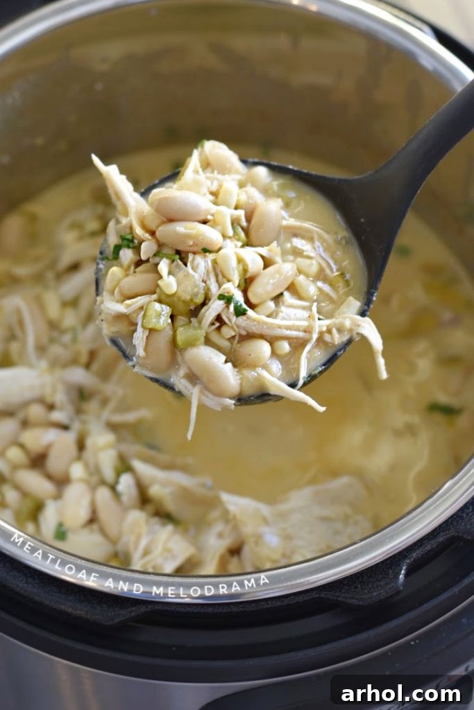 chicken chili with white beans on a ladle in the instant pot 