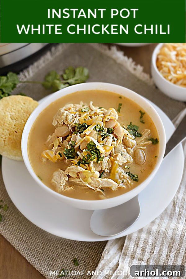 close up of white chicken chili in a bowl for pinterest