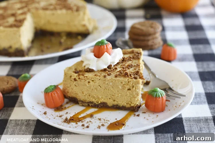 Velvety Instant Pot Pumpkin Cheesecake 2 Instant Pot Pumpkin Cheesecake with gingersnap crust, topped with whipped cream, caramel drizzle, and mini marshmallow pumpkins, presented on a white plate.