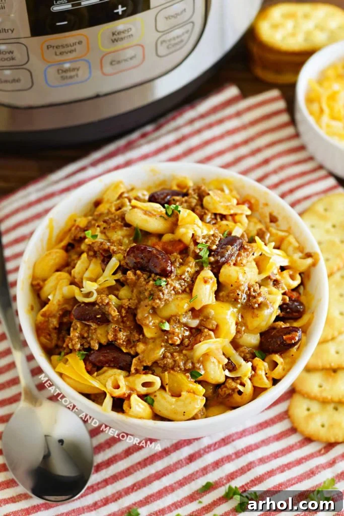 A serving bowl of delicious Instant Pot Chili Mac with ground beef, elbow macaroni, and kidney beans, ready to be enjoyed.