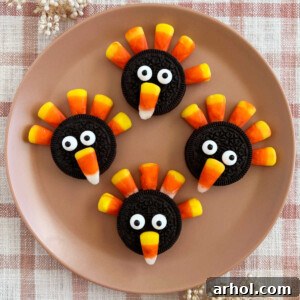 Oreo turkey cookies with Oreos and candy corn on a plate, ready to be served at Thanksgiving dinner.