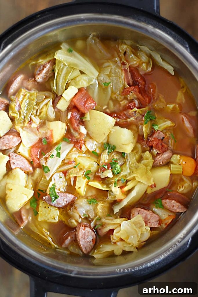 The finished Instant Pot Kielbasa Cabbage Soup with potatoes and sausage slices, still in the Instant Pot liner, ready to be served.
