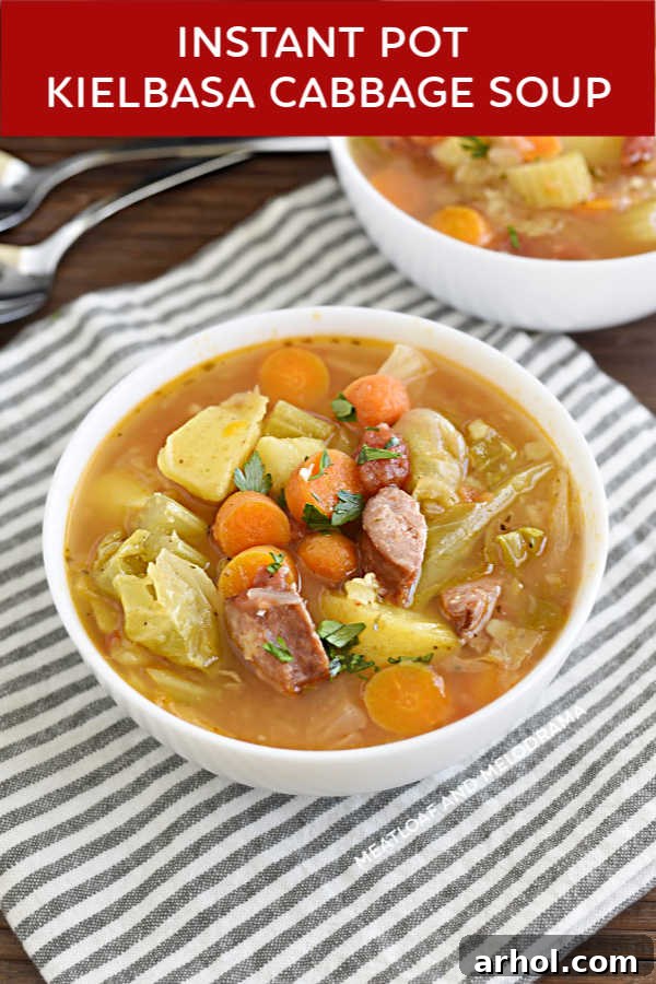 Close-up of Instant Pot Kielbasa Cabbage Soup in a white bowl, showing the texture of the vegetables and sausage.