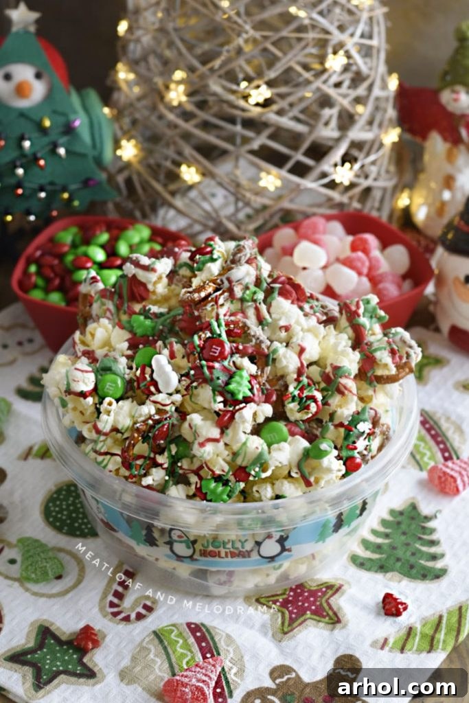 A festive bowl filled to the brim with colorful Christmas crunch popcorn pretzel snack mix, adorned with an assortment of holiday candies, elegantly placed on a table, ready for holiday enjoyment.