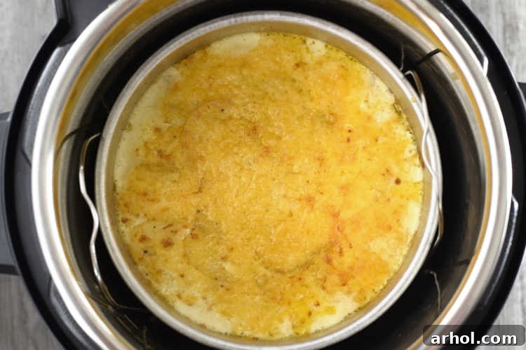 Freshly broiled scalloped potatoes au gratin, golden brown and bubbling, inside an Instant Pot Duo Crisp