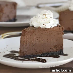 slice of instant pot chocolate cheesecake with whipped cream on a white plate