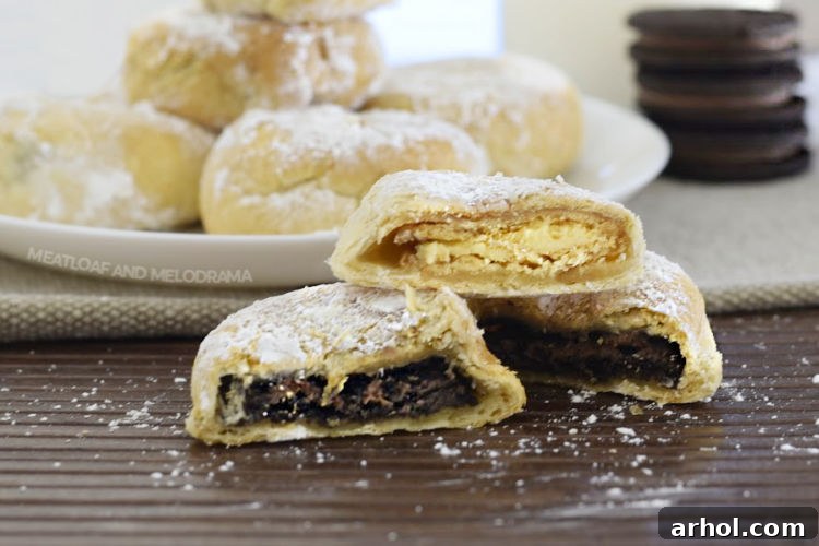 Two air fried Oreos, cut in half to reveal their warm, melted chocolatey interior, resting on a rustic brown mat.
