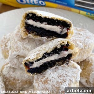 Air fryer fried Oreos coated in powdered sugar on a plate.
