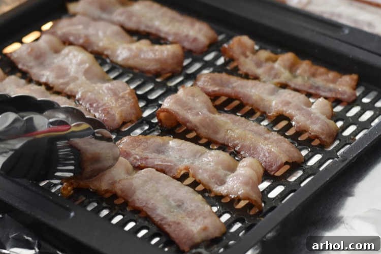 turn bacon over with tongs
