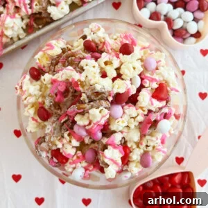 Valentine Day snack mix with popcorn and Valentine's Day candy on the table