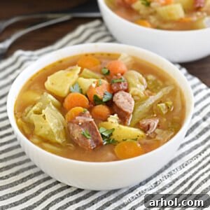 Bowl of Instant Pot kielbasa cabbage soup with potatoes and carrots