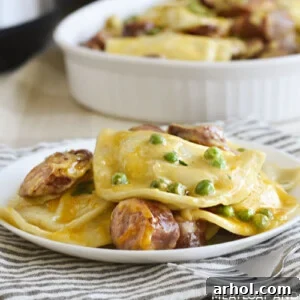 Instant Pot pierogi casserole with kielbasa and peas on a white plate
