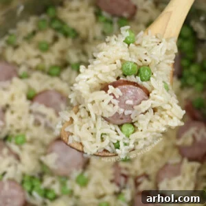 Kielbasa with rice and peas on wooden spoon in the pressure cooker