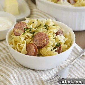 Instant Pot cabbage and noodles and kielbasa in white bowl