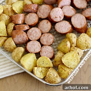 Sliced air fried kielbasa and potatoes in basket