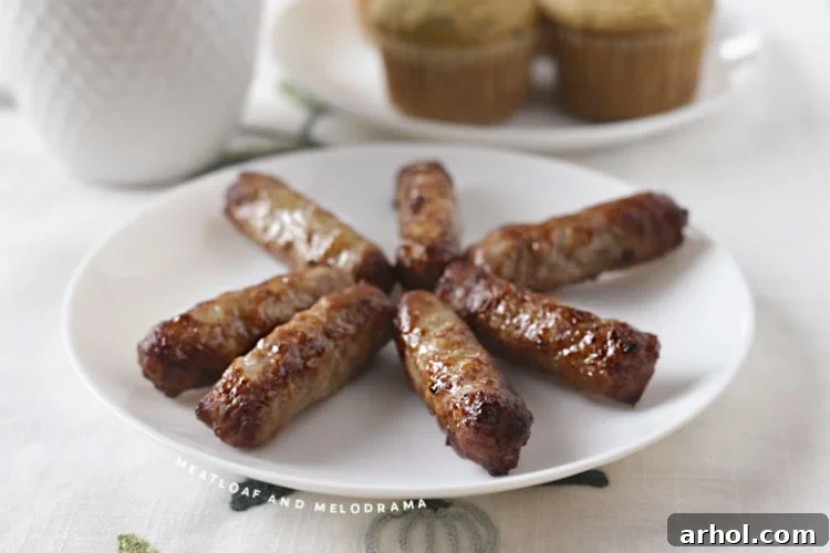 Crispy air fried breakfast sausage links arranged on a pristine white plate, ready to be served.