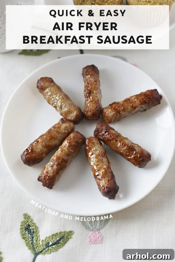 A close-up view of perfectly cooked breakfast sausage links nestled on a white plate, ready to be enjoyed.