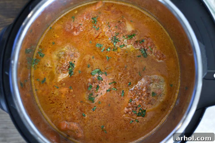 Instant Pot Catalina chicken simmering in its sweet and tangy sauce after pressure cooking.