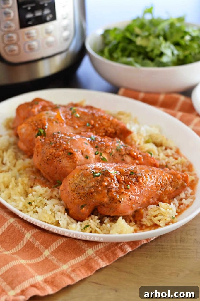 A serving platter with Instant Pot apricot chicken, an Instant Pot pressure cooker, and a fresh green salad in a bowl.