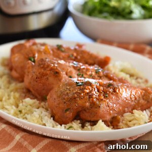 apricot chicken breasts over rice on a white platter