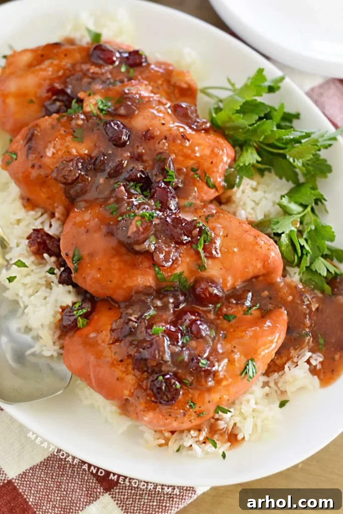 chicken breasts with cranberry sauce on a platter