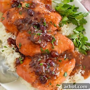 chicken breasts with cranberry sauce on a platter