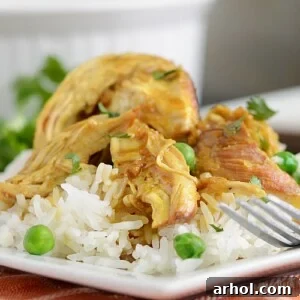 instant pot honey mustard curry chicken over jasmine rice on a plate