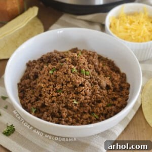 instant pot ground bee taco meat in a white bowl with cilantro