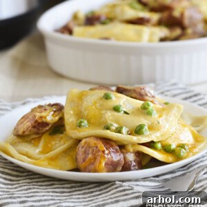 instant pot pierogi casserole with kielbasa and peas on a white plate