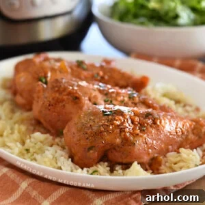 apricot chicken breasts over rice on a white platter