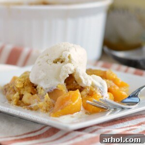 instant pot peach dump cake with vanilla ice cream on plate