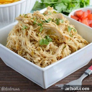 instant pot salsa verde chicken shredded in white bowl