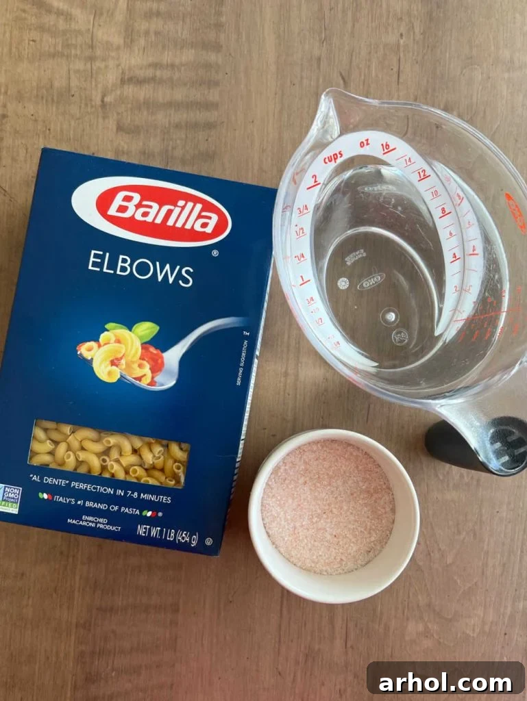 A box of elbow macaroni, a bowl of water, and a pinch of sea salt, the three simple ingredients for Instant Pot pasta.