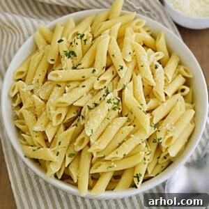 A beautiful bowl of penne pasta, garnished with fresh parsley and grated Parmesan cheese, showcasing the perfect results from the Instant Pot.