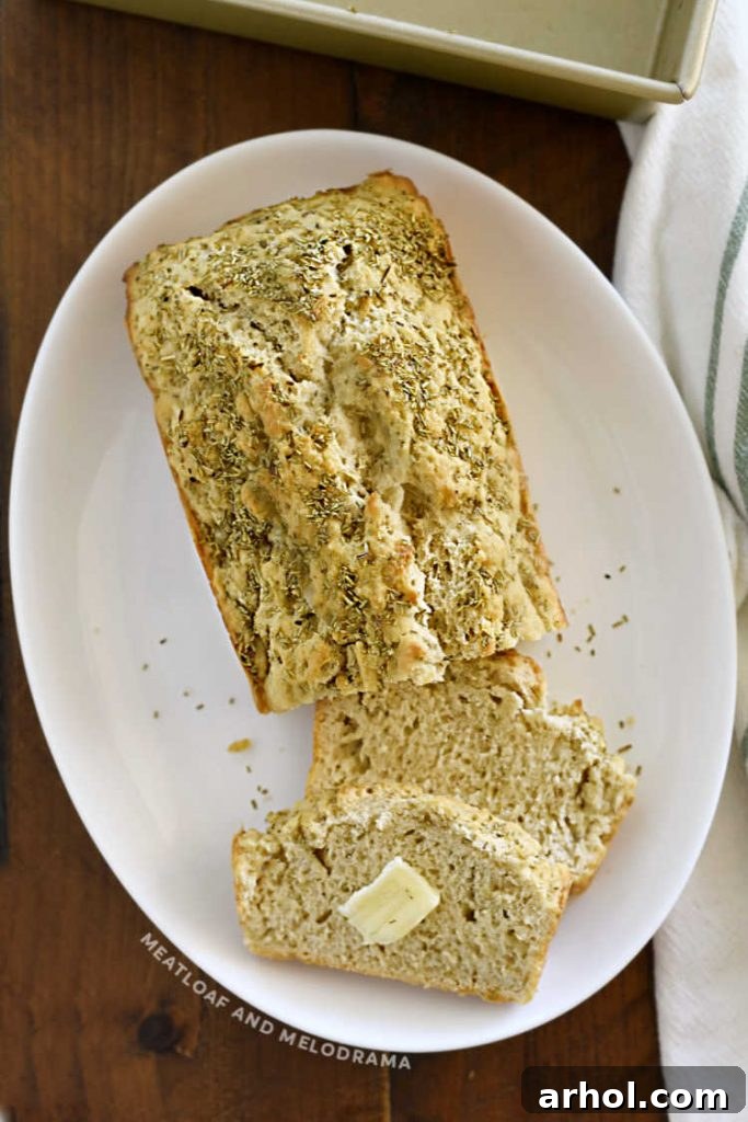 sliced rosemary beer bread on a white platter