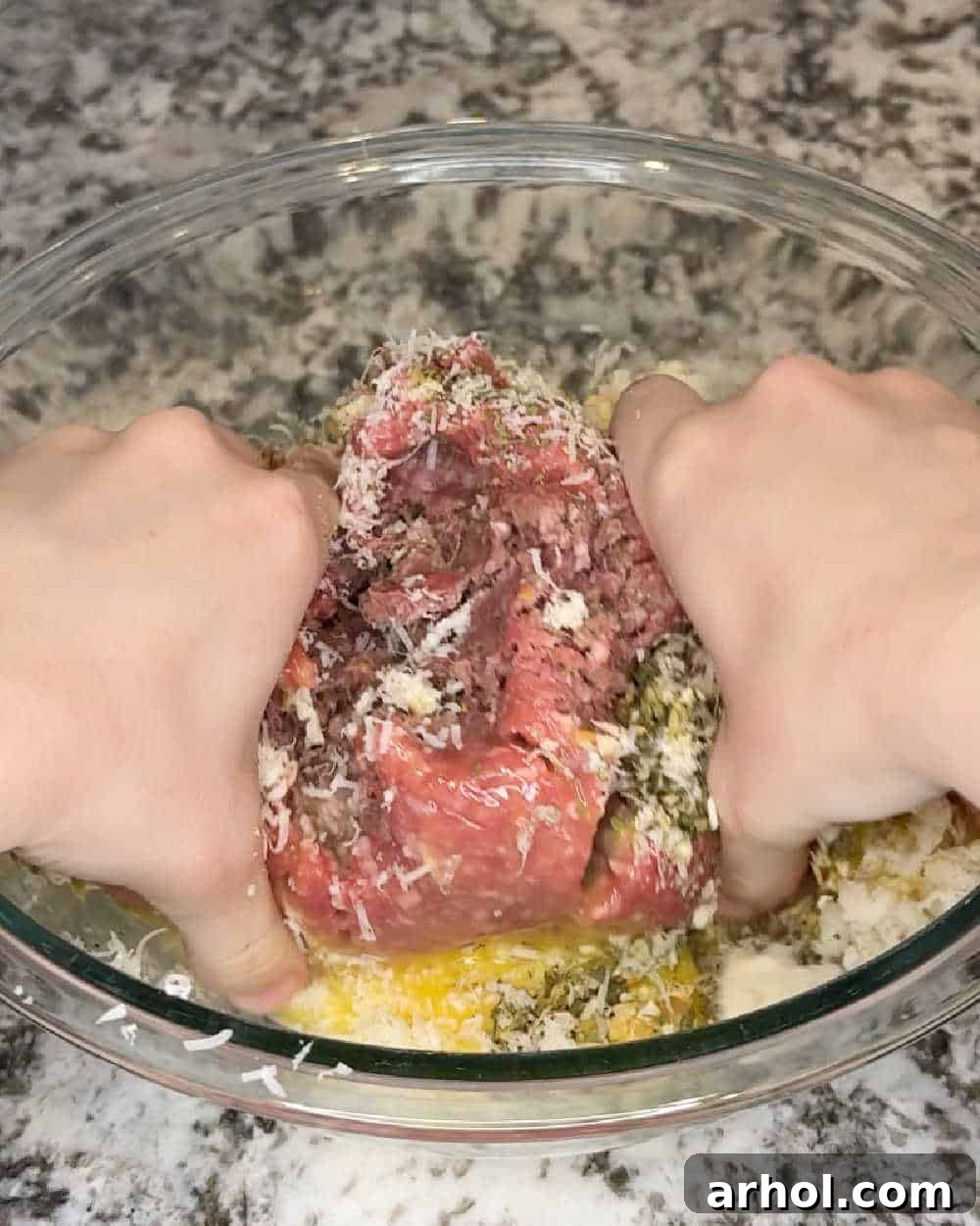 Step 2: Gently mix ground beef, sausage, soaked bread, eggs, and spices in a large bowl with hands.